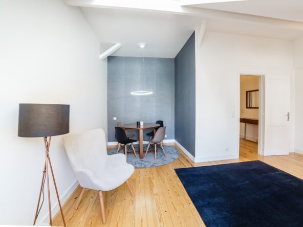 Modern apartment with white walls and light wooden floor